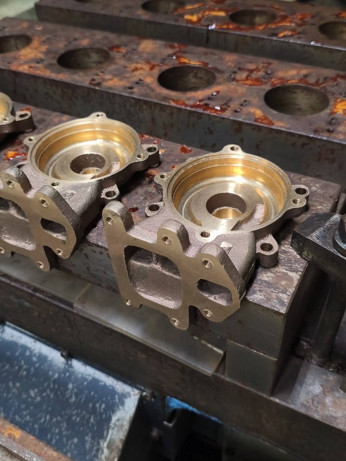 Cast iron pump impeller covers after face milling, boring, drilling and tapping on a Makino S33 — cast part machining, Bangkok